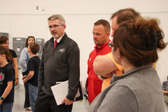 Robbie Fletcher talks to a group of people