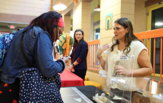 Saylor Fortner, a graduate student with the University of Louisville, explains part of the exhibit the university created with the Kentucky School for the Blind (KSB), exploring the history of the KSB Segregated Department