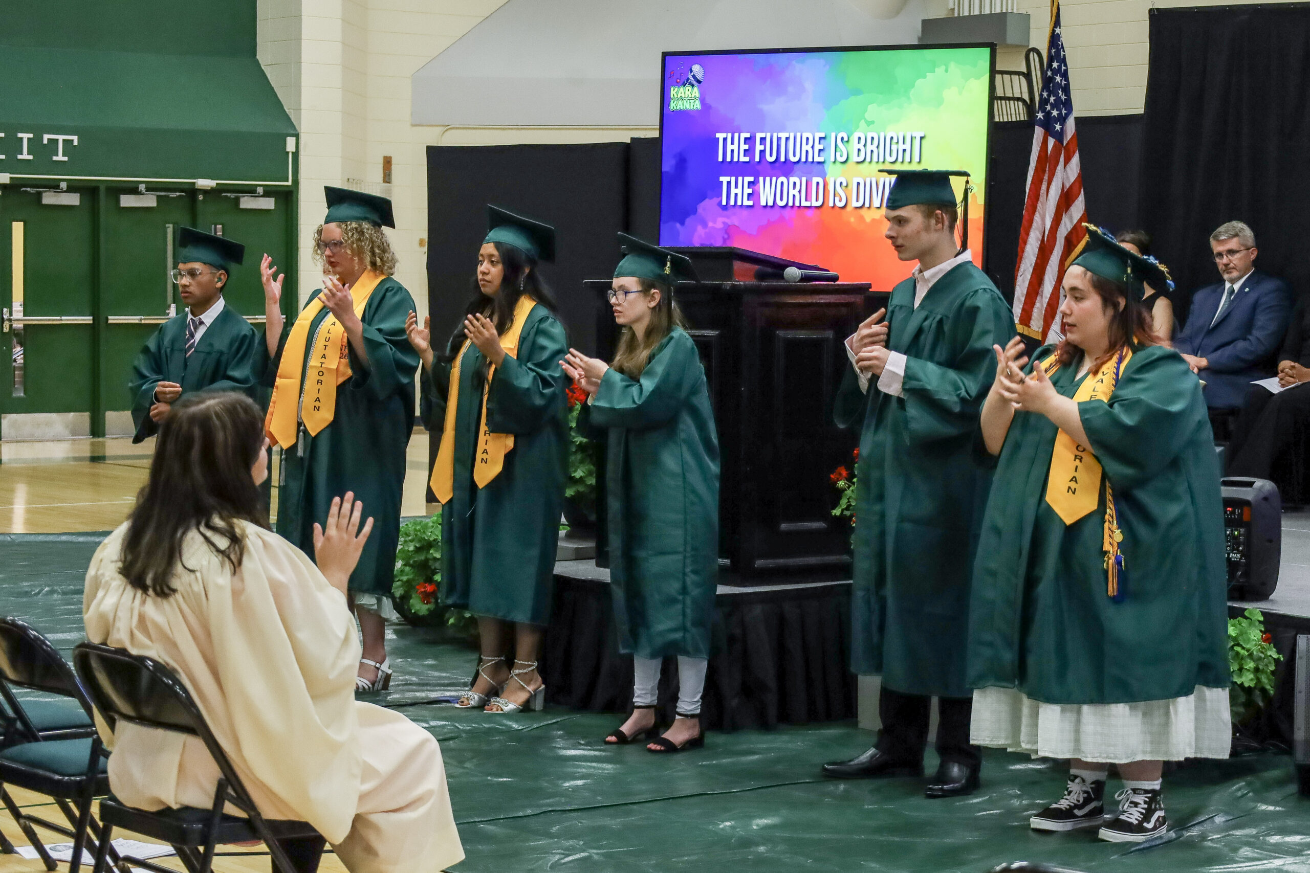 During the commencement ceremony, all six graduates performed a song in American Sign Language called “Dreams We Hold” for the audience. The graduates stand in front of the stage performing the song