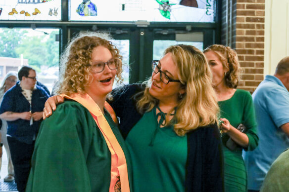KSD graduate Raigan Privett, left, speaks to a friend after the ceremony.