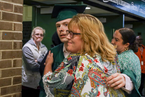 KSD graduate Michael Cooper, left, hugs a friend after the ceremony.