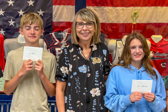 Jennifer Fraley poses with two students for a photo