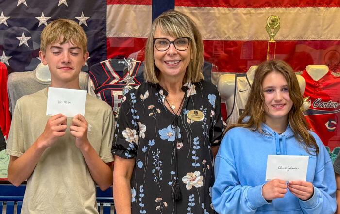 Jennifer Fraley poses with two students for a photo