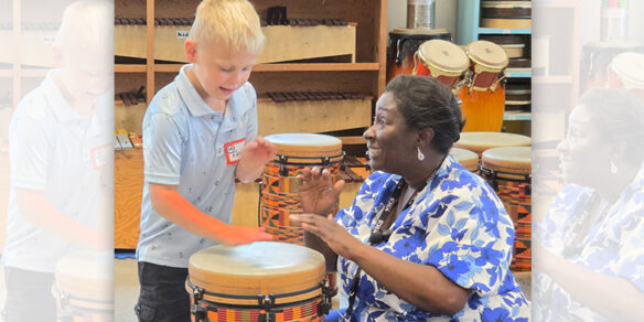 A teacher playing a drum with a student.